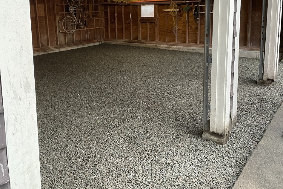 Angled shot of the garage floor with beautifully flat gray gravel.